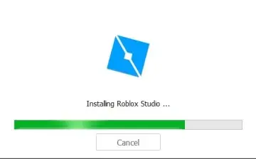 Alt text: "Roblox Studio installation screen with a blue diamond logo. A green progress bar shows installation in progress, with a cancel button below."